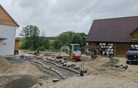 Baggerbetrieb-Franken_Ott_Nuernberg_Gartengestaltung Das Bild zeigt einen Bagger der Firma Baggerbetrieb Franken bei der Gartengestaltung - Erdbewegung Nürnberg